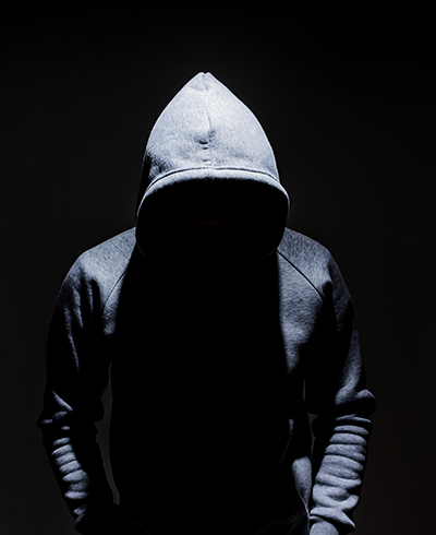 sinister figure wearing a hoodie