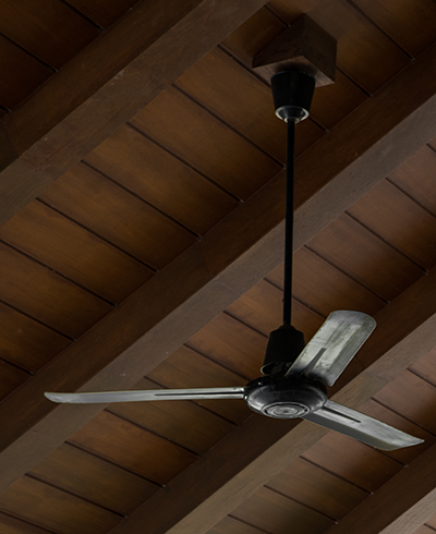 fan against the background of a wooden beamed ceiling background
