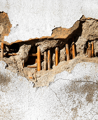 wall of reinforced concrete crumbling
