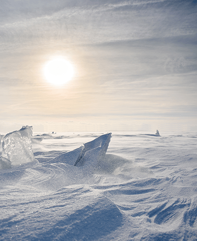 frozen arctic landscape under a hazy sun